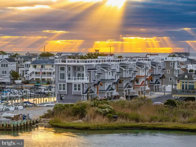 a view of a lake with a building and trees in the background