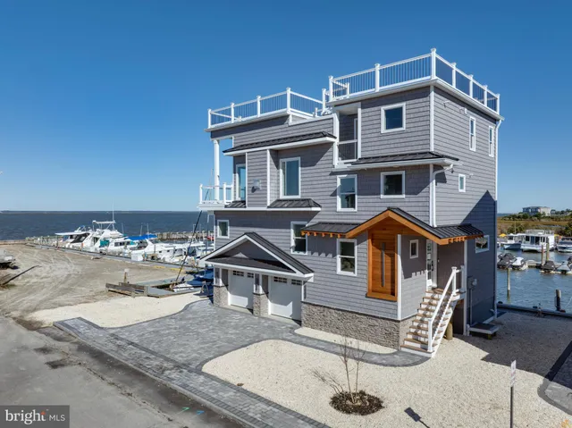a view of residential houses with outdoor space and lake view