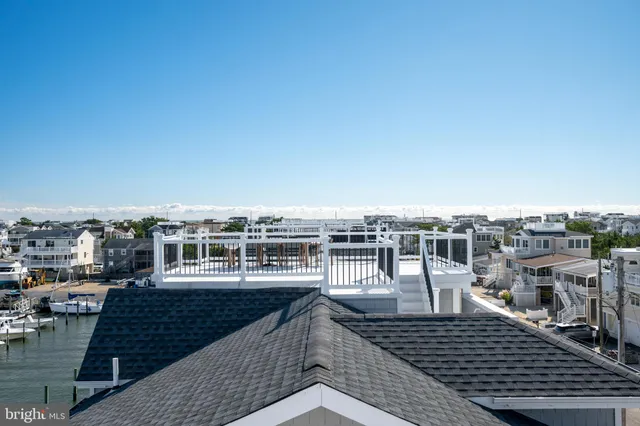 a front view of a building with a garden and plants
