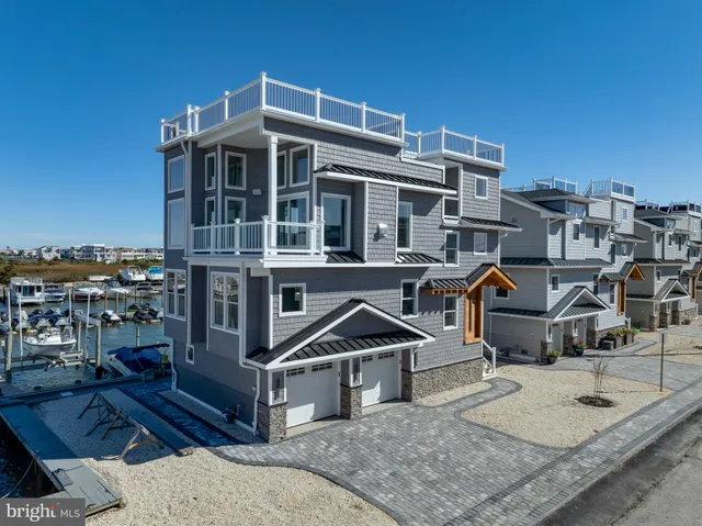 a picture of table and chairs with the ocean view