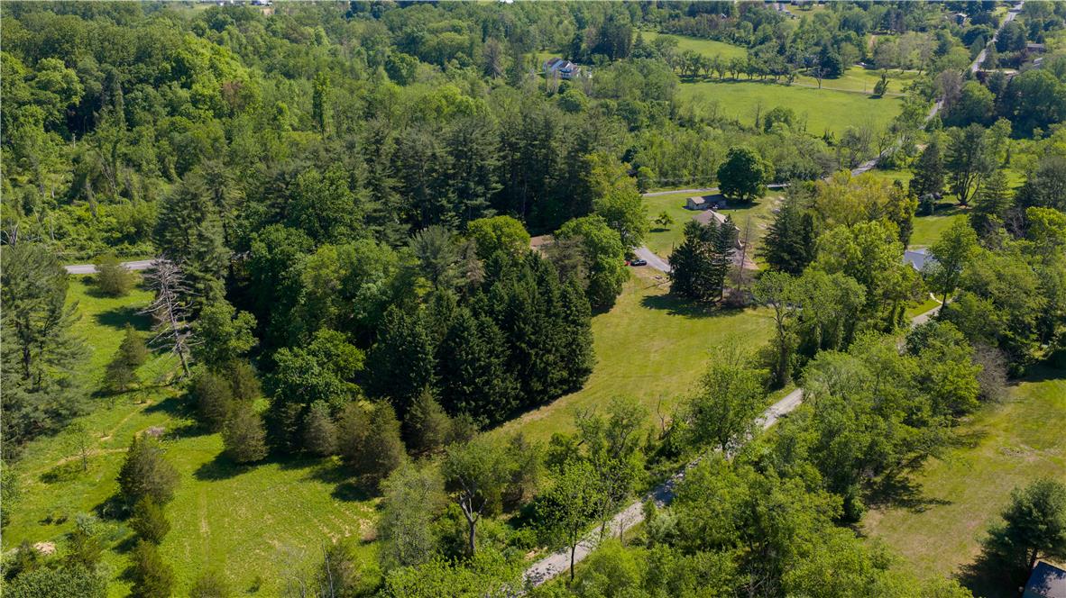 Coldsprings Rd Union Pottstown, PA 19465 - Photo 8 of 71 An aerial perspective reveals a vast, verdant landscape with scattered homes and winding roads, offering a peaceful rural setting.