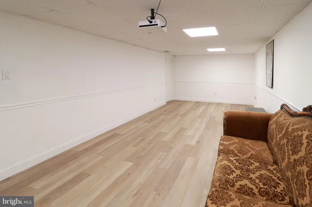 a bed room with a bed and a painting on the wall