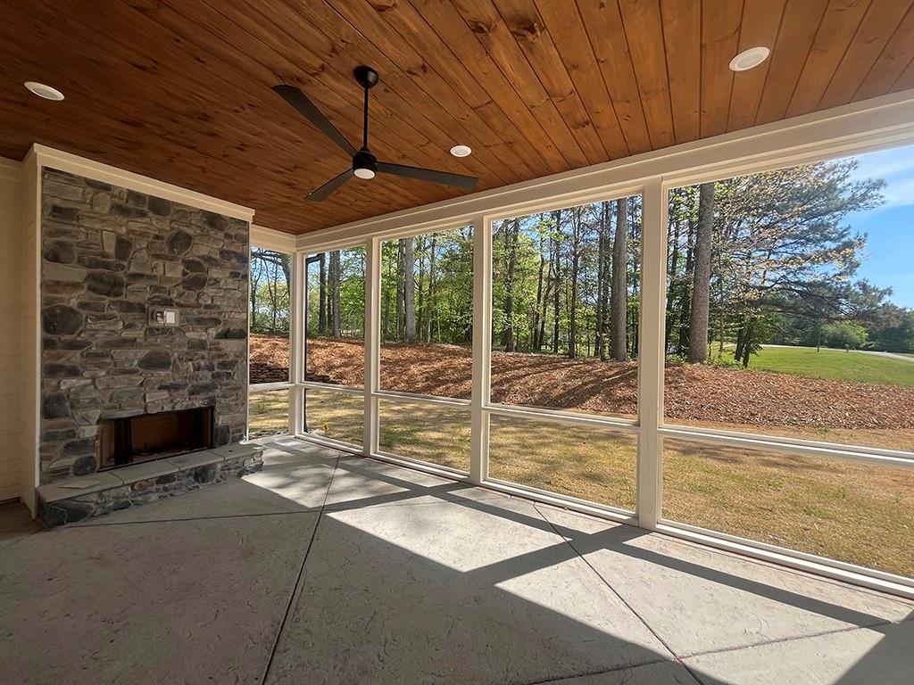 2200 Upper Burris Road Ball Ground, GA 30107 - Photo 11 of 79 a view of an empty room with wooden floor and a fireplace