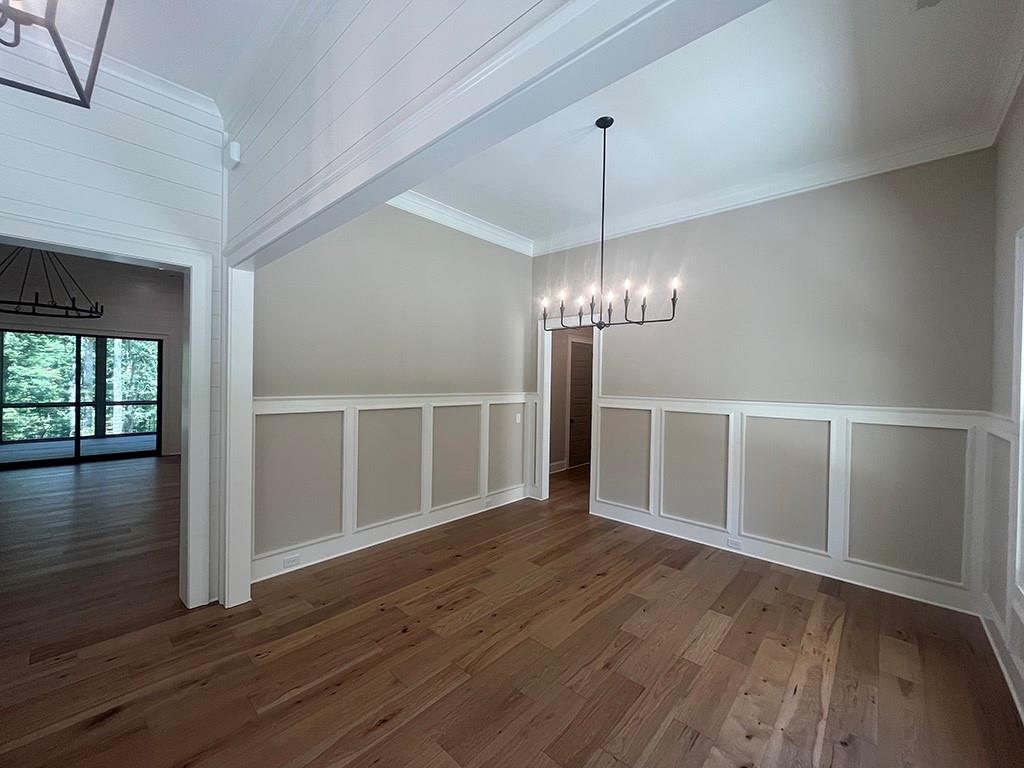 2200 Upper Burris Road Ball Ground, GA 30107 - Photo 14 of 79 a view of a livingroom with wooden floor staircase and a kitchen space