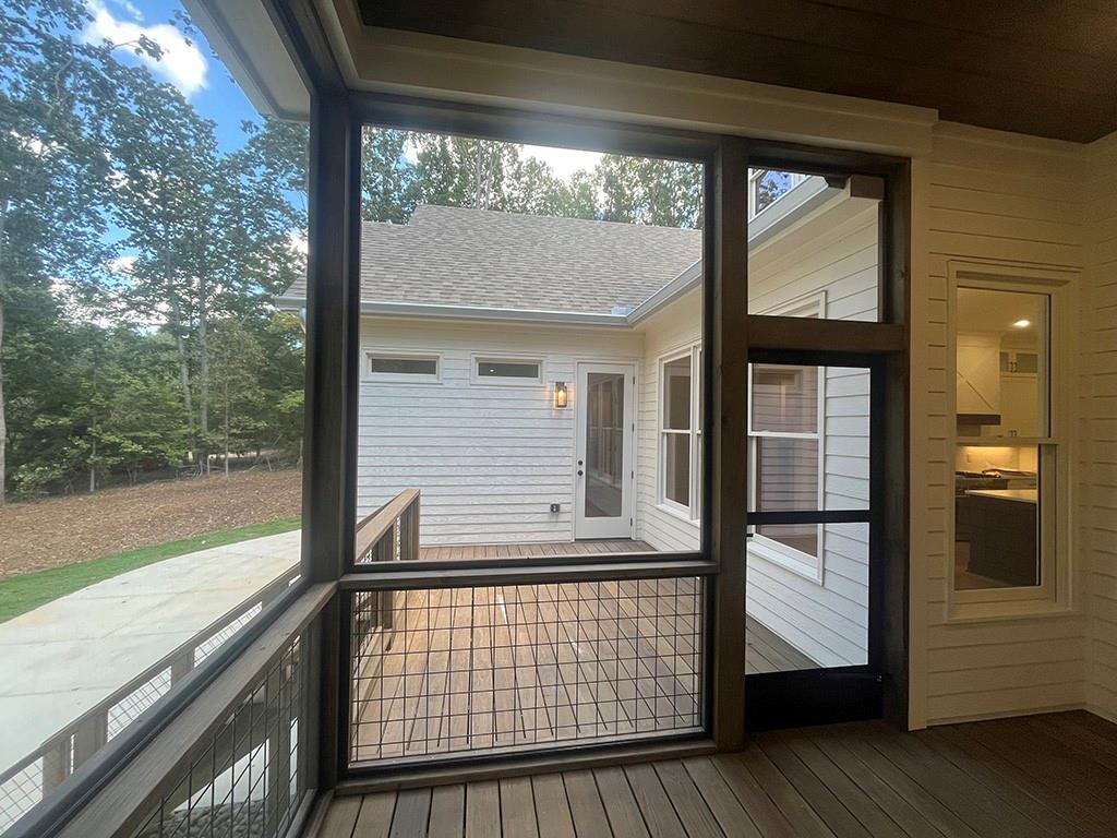 2200 Upper Burris Road Ball Ground, GA 30107 - Photo 23 of 79 a view of balcony with floor to ceiling window wooden floor and deck
