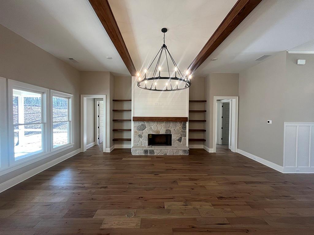 2200 Upper Burris Road Ball Ground, GA 30107 - Photo 45 of 79 a view of a livingroom with a fireplace wooden floor and staircase