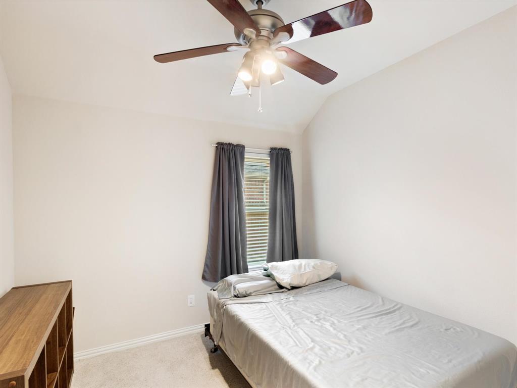 5440 Lavaca Road Grand Prairie, TX 75052 - Photo 10 of 22 Vaulted ceiling with an attached ceiling fan, window with blinds, and light-colored wall-to-wall carpeting