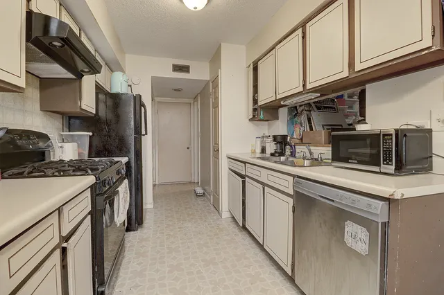 a kitchen with cabinets and appliances