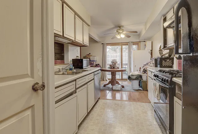 a bathroom with a granite countertop toilet and a sink
