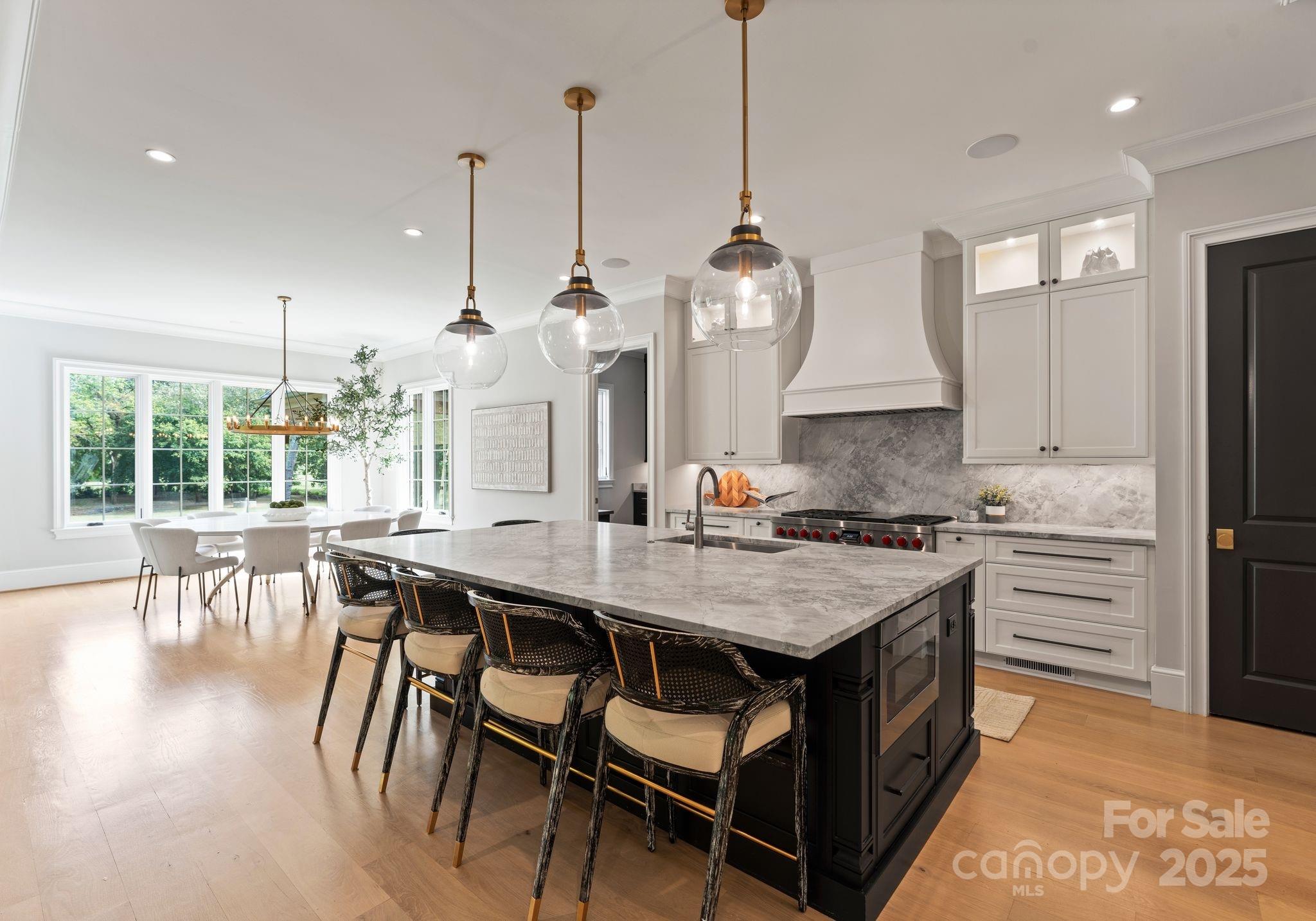 4019 River Ridge Road Charlotte, NC 28226 - Photo 9 of 39 a open kitchen with stainless steel appliances granite countertop a stove a refrigerator a kitchen island a dining table and chairs