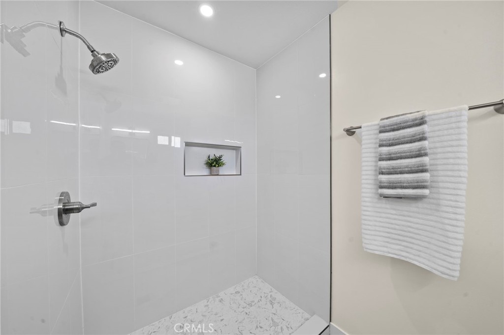 9561 Cardinal Avenue Westminster, CA 92683 - Photo 20 of 34 the primary bath features a walk-in shower, while the hall bath offers a tub/shower combo, both with beautiful designer surrounds