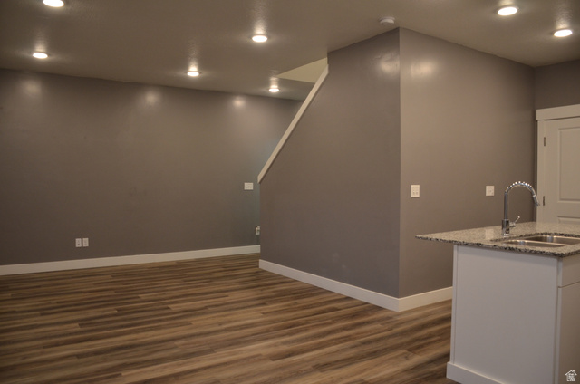 1842 South 1280th Street West Logan, UT 84321 - Photo 7 of 21 Open-concept living space featuring wood-finish flooring, recessed lighting, and a neutral wall palette