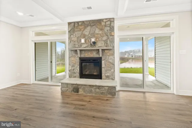a view of an empty room with a fireplace and a window