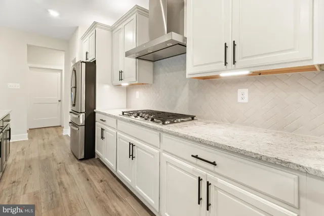 a kitchen with sink a stove and cabinets