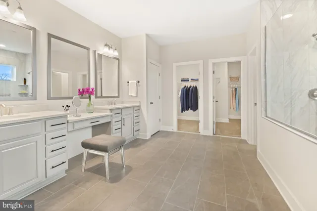 a spacious bathroom with a sink shower and a mirror