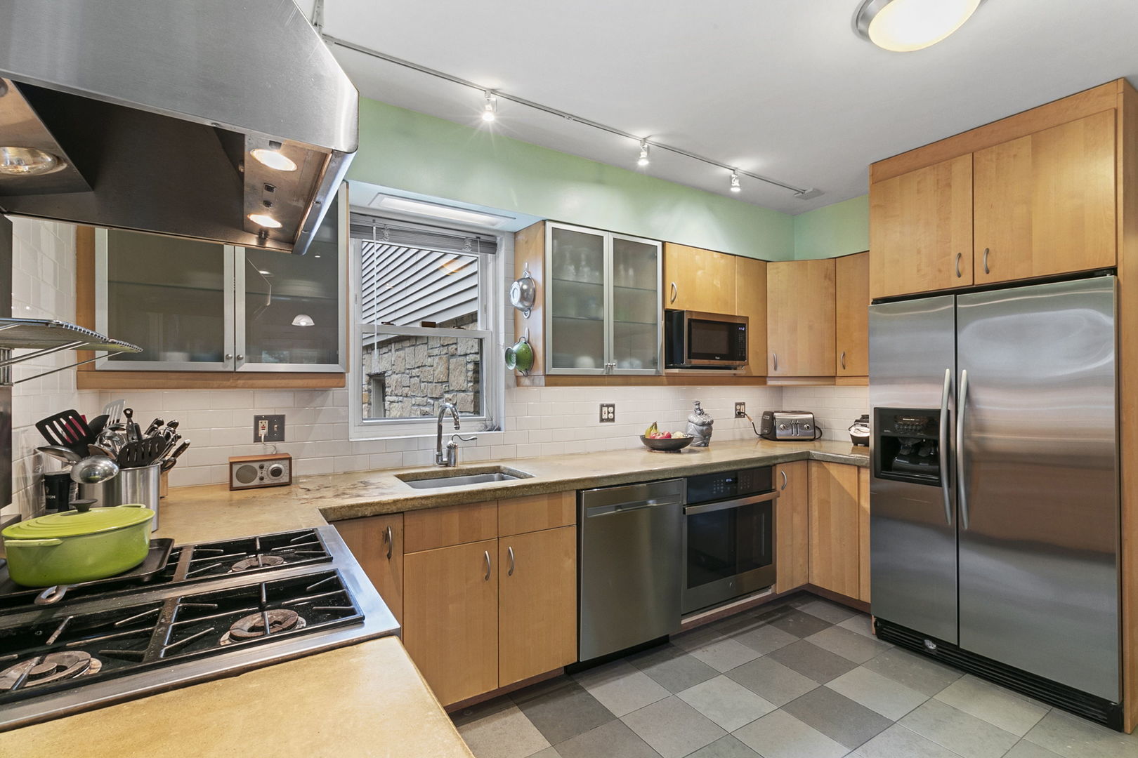 333 Addison Road Riverside, IL 60546 - Photo 7 of 14 a kitchen with stainless steel appliances a sink a stove and a refrigerator