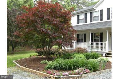 7250 Mackall Road St. Leonard, MD 20685 - Photo 1 of 27 a front view of a house with a yard
