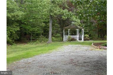 7250 Mackall Road St. Leonard, MD 20685 - Photo 11 of 27 a view of a house with backyard and a garden