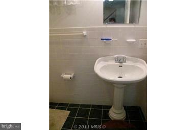 7250 Mackall Road St. Leonard, MD 20685 - Photo 12 of 27 a bathroom with a sink and a mirror