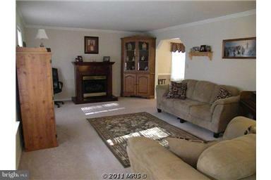 7250 Mackall Road St. Leonard, MD 20685 - Photo 15 of 27 a living room with furniture and a fireplace