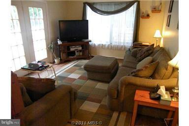 7250 Mackall Road St. Leonard, MD 20685 - Photo 16 of 27 a living room with furniture and a flat screen tv