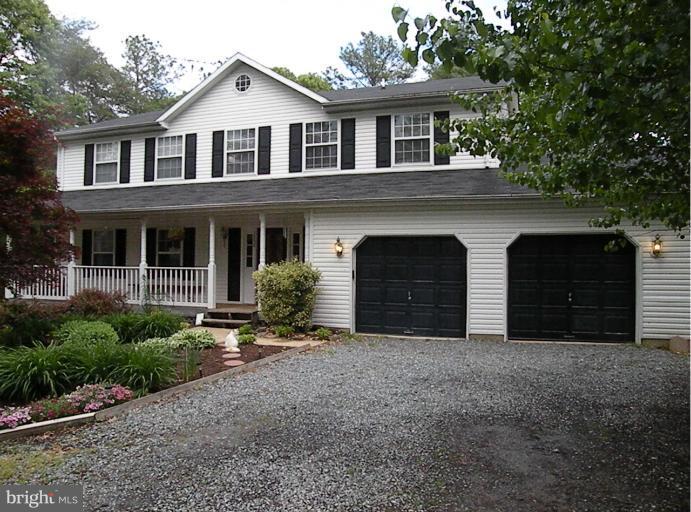 7250 Mackall Road St. Leonard, MD 20685 - Photo 18 of 27 a front view of a house with yard and parking space