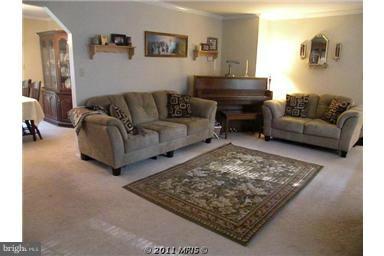 7250 Mackall Road St. Leonard, MD 20685 - Photo 3 of 27 a living room with furniture and a rug
