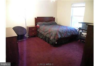 7250 Mackall Road St. Leonard, MD 20685 - Photo 4 of 27 a bedroom with a bed chair and window