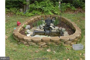 7250 Mackall Road St. Leonard, MD 20685 - Photo 8 of 27 a front view of a house with a yard