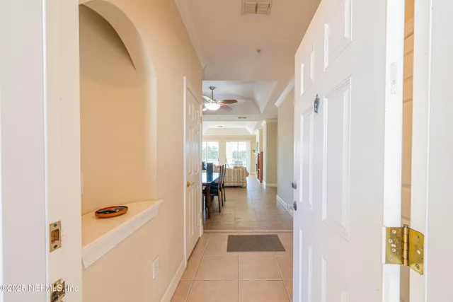 a view of a hallway with dining area and glass door