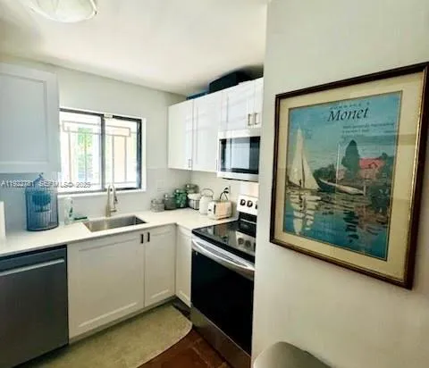 a kitchen with a sink stove and microwave