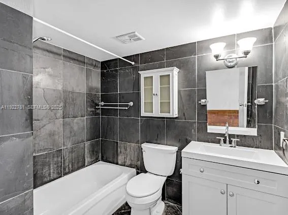 a bathroom with a sink a toilet a mirror and shower