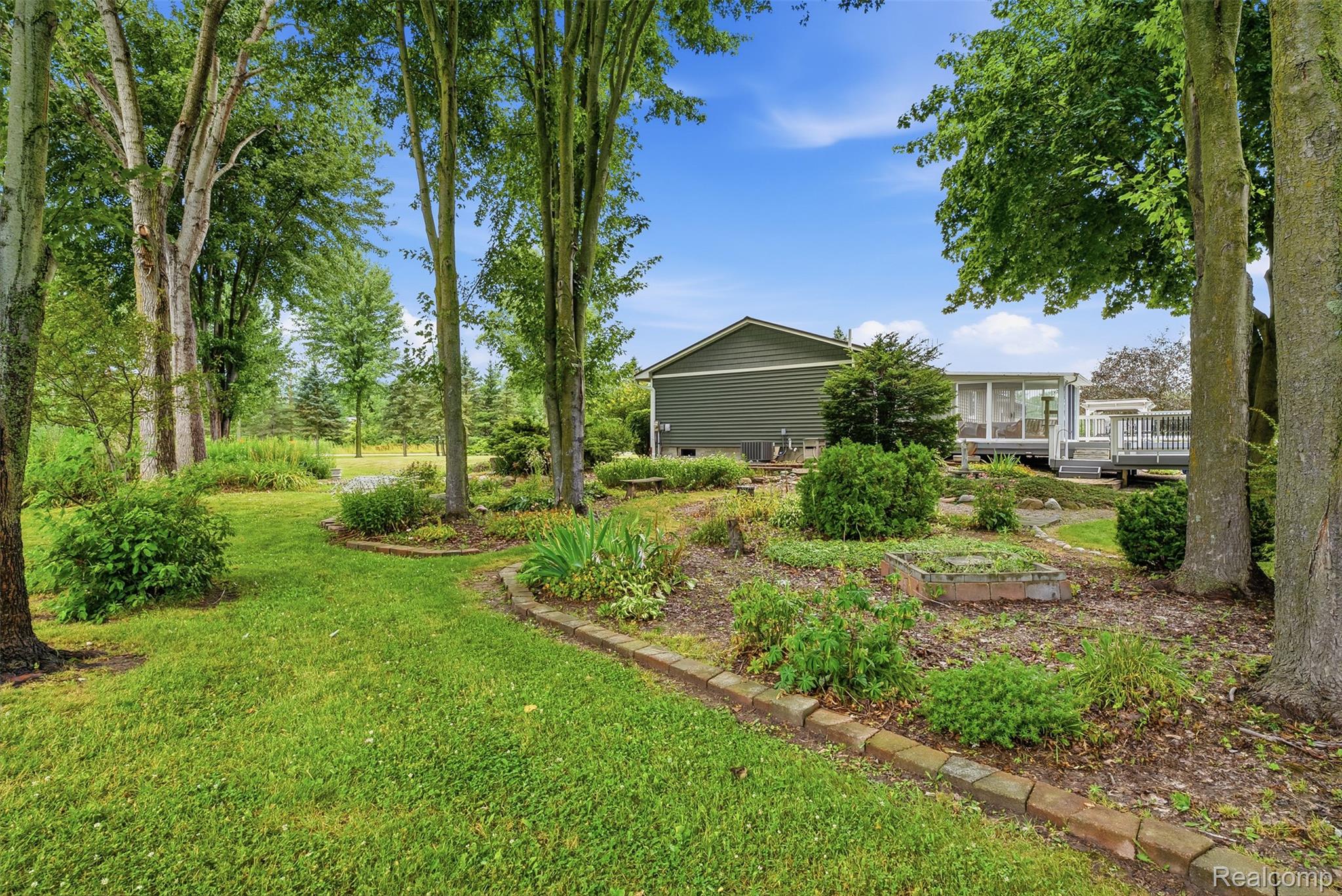 13182 Gilbert Road Memphis, MI 48041 - Photo 38 of 48 Expansive lawn bordered by mature trees and landscaped garden beds