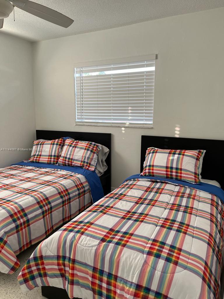 442 Southwest 9th Street, Unit 3 Miami, FL 33130 - Photo 3 of 10 a bedroom with two beds and two windows