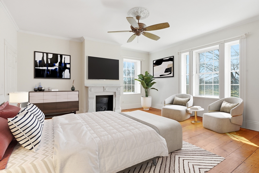 96 Washington Square East, Unit 2 Salem, MA 01970 - Photo 12 of 40 a bedroom with a bed a couch and a flat screen tv
