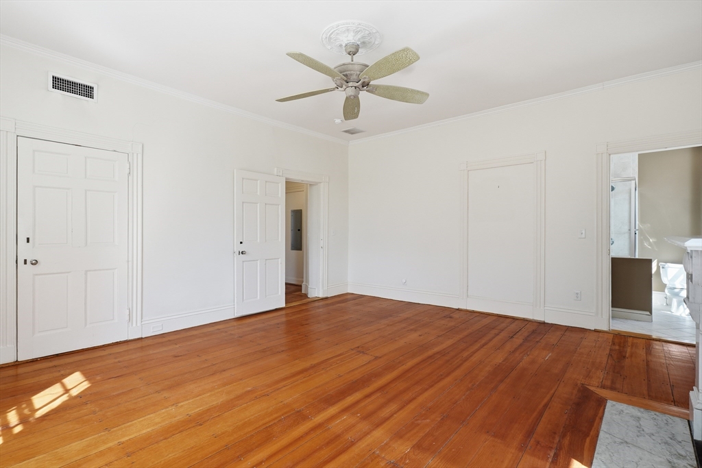 96 Washington Square East, Unit 2 Salem, MA 01970 - Photo 13 of 40 a view of empty room with wooden floor and ceiling fan