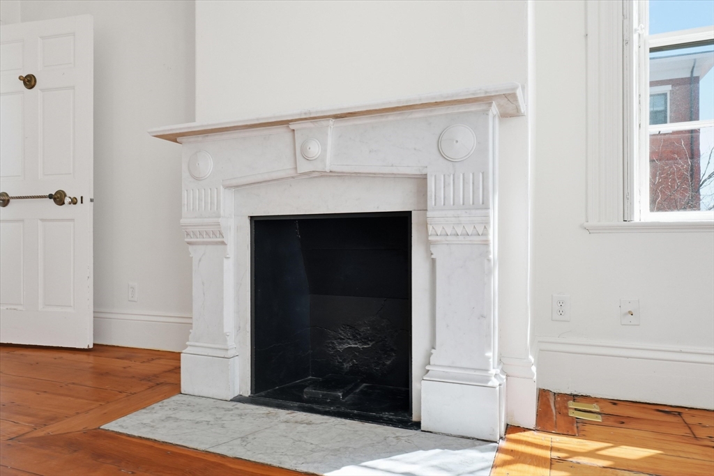 96 Washington Square East, Unit 2 Salem, MA 01970 - Photo 16 of 40 a view of a livingroom with wooden floor and a fireplace