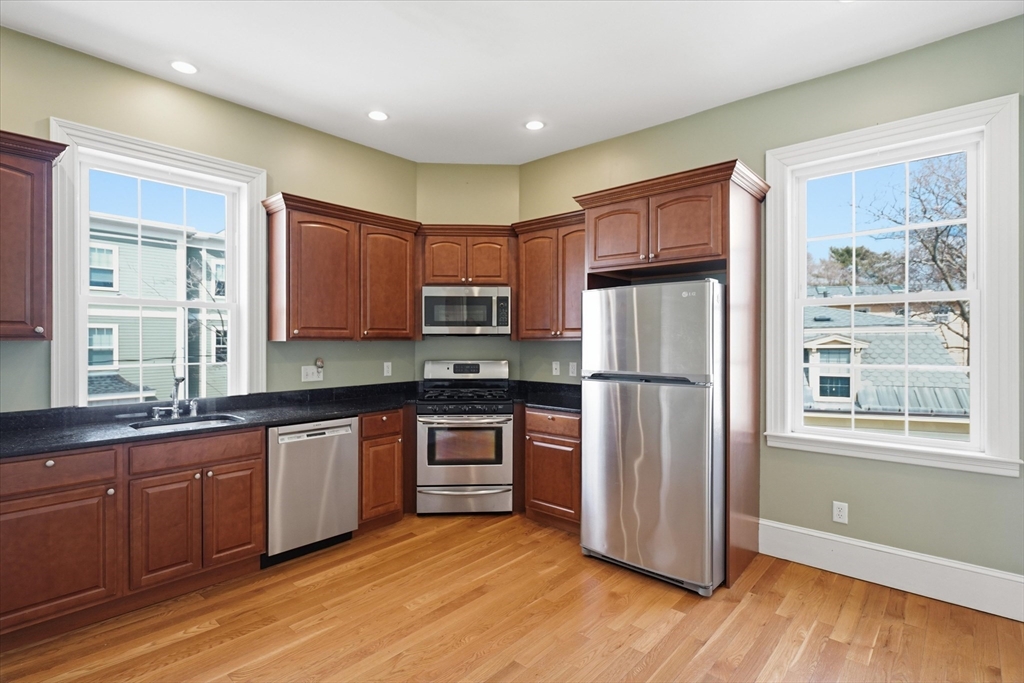 96 Washington Square East, Unit 2 Salem, MA 01970 - Photo 20 of 40 a kitchen with stainless steel appliances granite countertop a refrigerator and a stove top oven