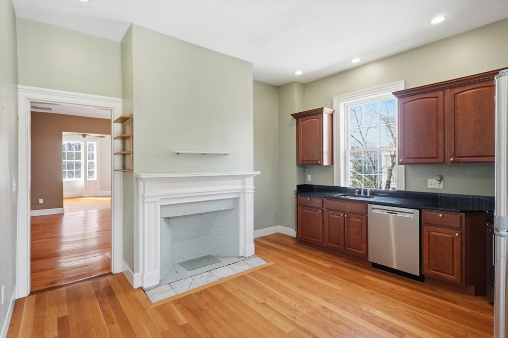 96 Washington Square East, Unit 2 Salem, MA 01970 - Photo 22 of 40 a kitchen with granite countertop wooden floors and stainless steel appliances
