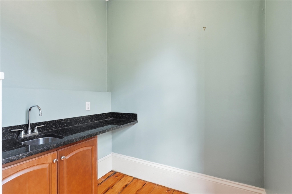 96 Washington Square East, Unit 2 Salem, MA 01970 - Photo 29 of 40 a close view of a sink and dishwasher with kitchen island