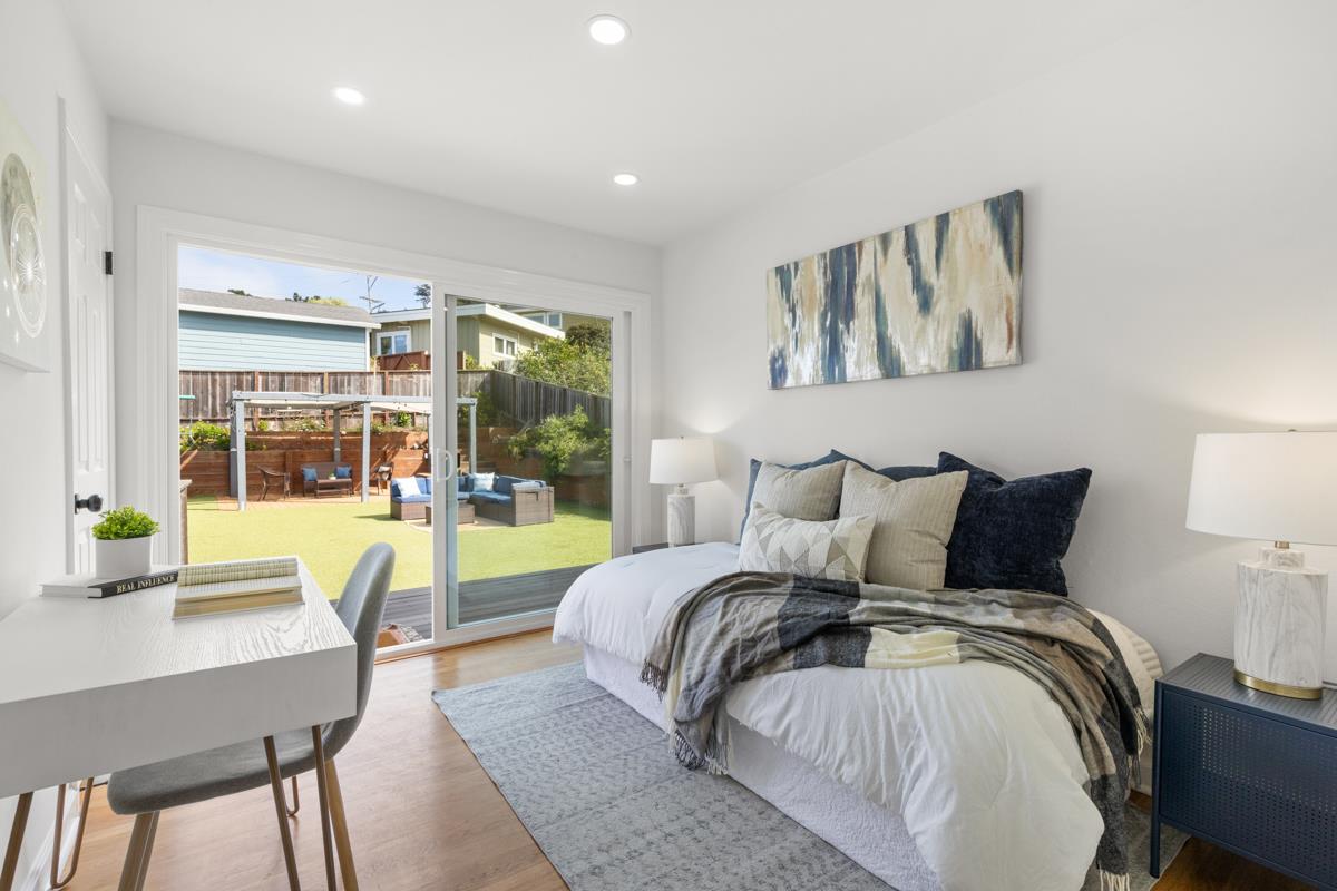 383 Monterey Road Pacifica, CA 94044 - Photo 19 of 33 a bedroom with a large bed and a large window