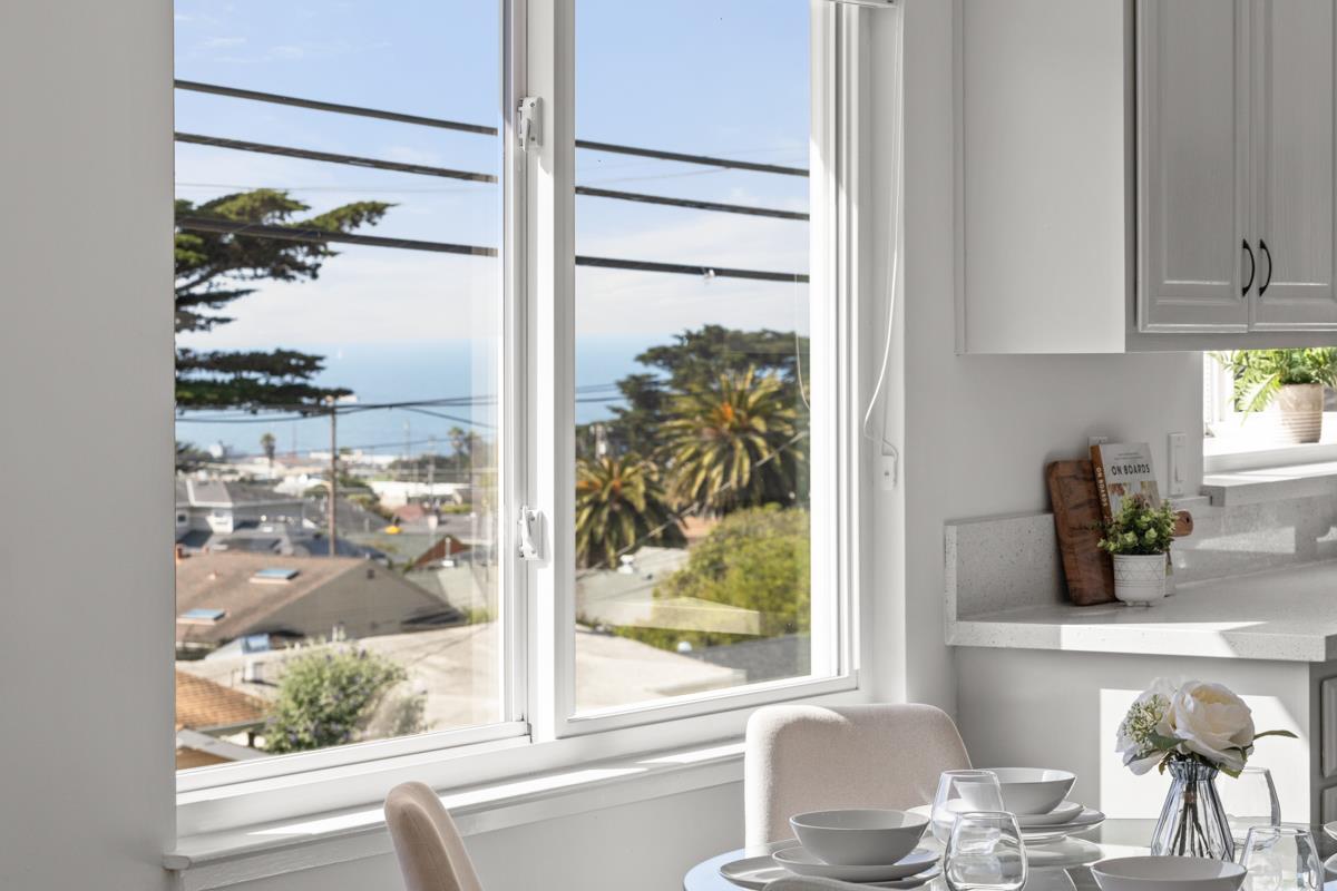 383 Monterey Road Pacifica, CA 94044 - Photo 6 of 33 a kitchen with a window and a white table