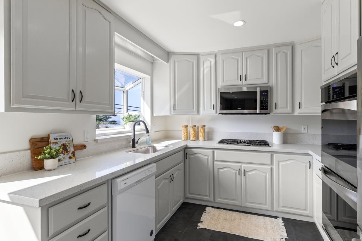 383 Monterey Road Pacifica, CA 94044 - Photo 9 of 33 a kitchen with cabinets stainless steel appliances a sink a window and cabinets