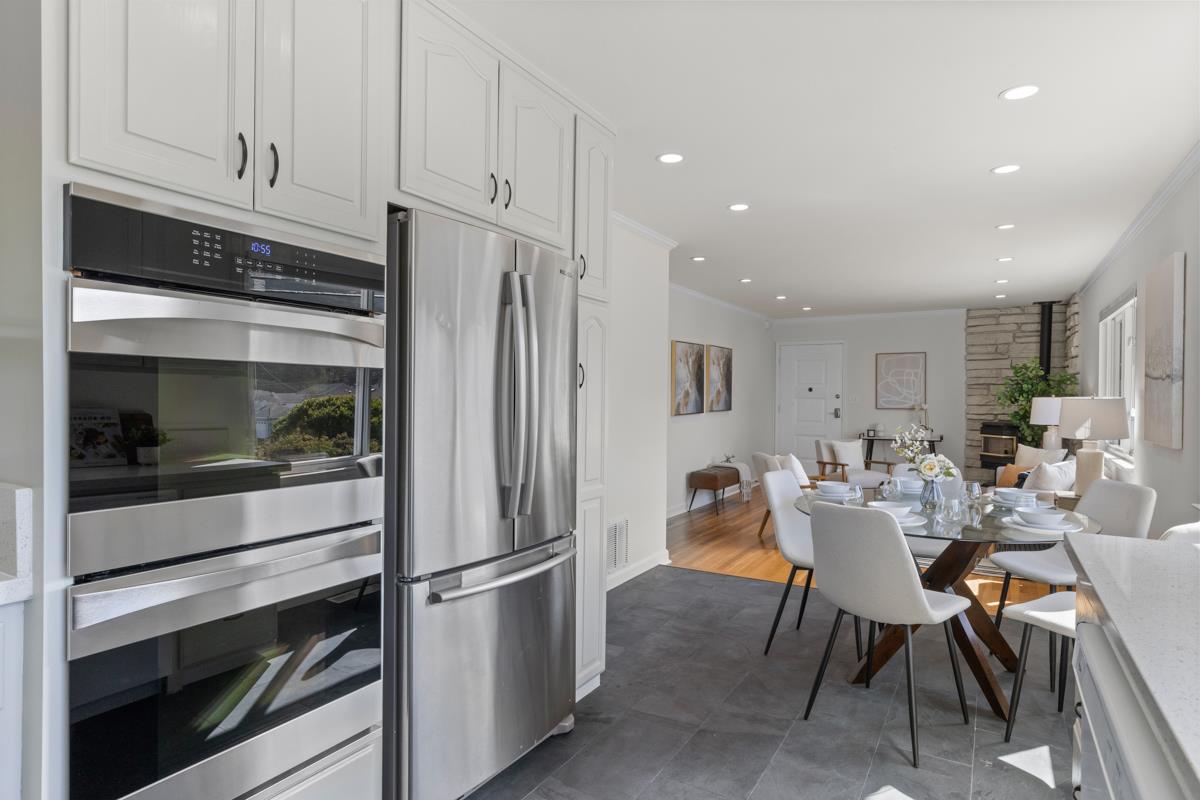 383 Monterey Road Pacifica, CA 94044 - Photo 10 of 33 a kitchen with stainless steel appliances white cabinets and a refrigerator