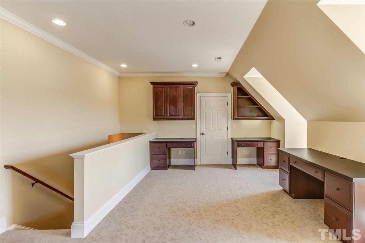 3312 Cotten Road Raleigh, NC 27603 - Photo 22 of 30 Huge Bonus Room with lots on built in shelving and storage.