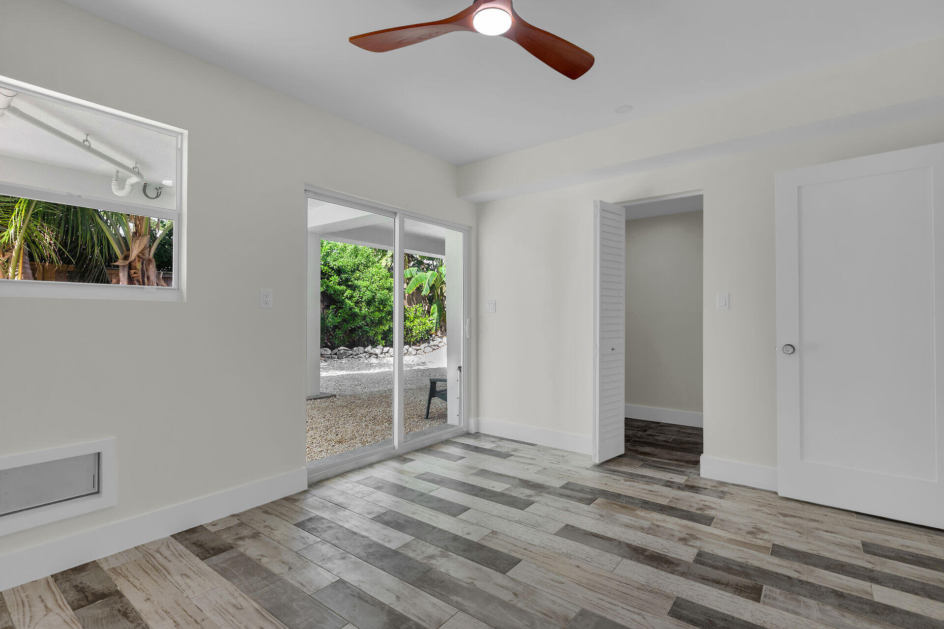 147 Sioux Street Tavernier, FL 33070 - Photo 39 of 41 a view of empty room with wooden floor and fan