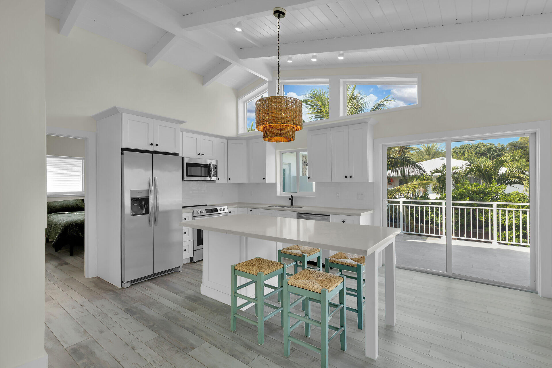 147 Sioux Street Tavernier, FL 33070 - Photo 10 of 41 a dining room with stainless steel appliances kitchen island granite countertop a table chairs refrigerator and sink