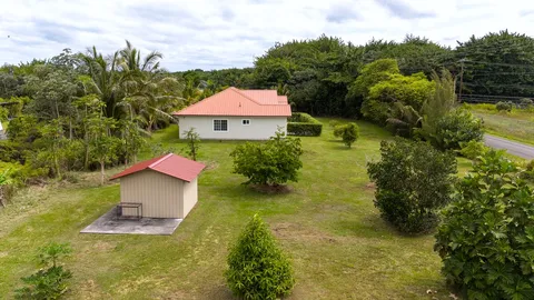 an aerial view of residential houses with yard