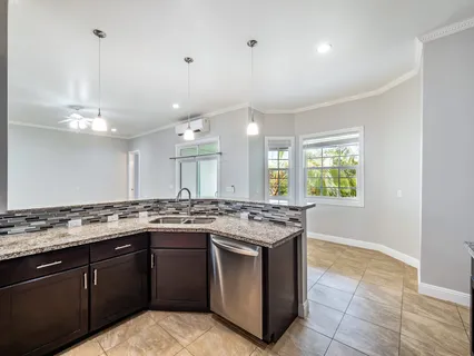 a kitchen with a sink stove and cabinets