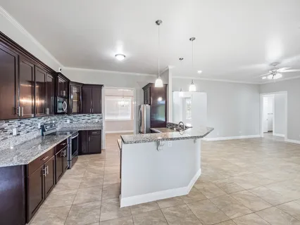 a kitchen with stainless steel appliances granite countertop a stove and a sink